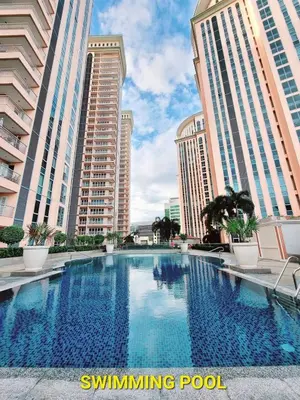 a large swimming pool in front of tall buildings at Elegant Condo at Venice Grand Canal BGC #vlrtc27e in Manila