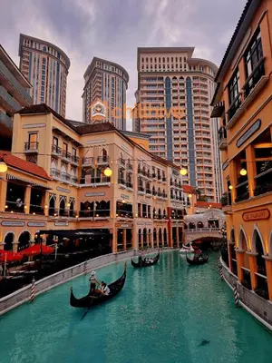 a group of gondolas in a river in a city at Elegant Condo at Venice Grand Canal BGC #vlrtc27e in Manila