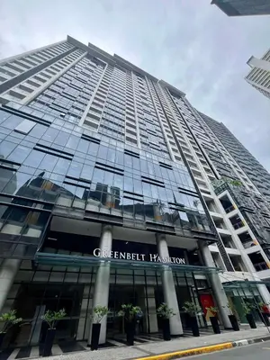 a large building with plants in front of it at Greenbelt Hamilton Tower 1 Legazpi Makati City - by ES Elite Suites in Manila