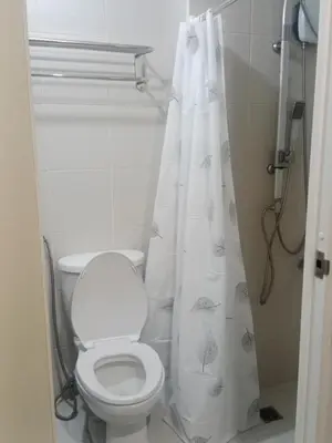 a bathroom with a toilet and a shower curtain at Jazz stacation in Manila