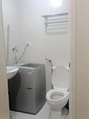 a bathroom with a toilet and a sink at Jazz stacation in Manila