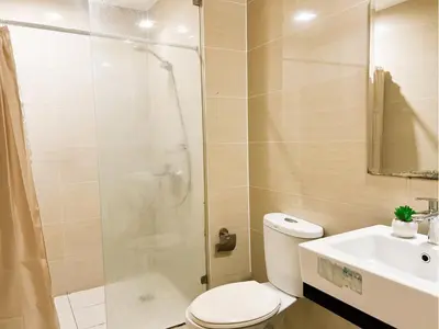 a bathroom with a shower and a toilet and a sink at BGC Luxury, Venice Grand Canal Mall #vlrtc27c in Manila