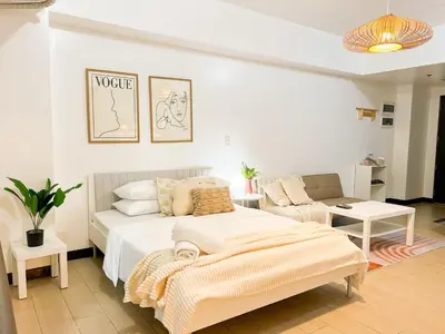 a bedroom with a bed and a couch at BGC Luxury, Venice Grand Canal Mall #vlrtc27c in Manila