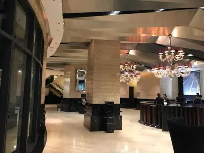 a lobby with a bar and chandeliers in a building at Makati City Studio with Balcony Near Bgc And Airport in Manila