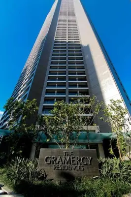 a tall building with a sign in front of it at Makati City Studio with Balcony Near Bgc And Airport in Manila