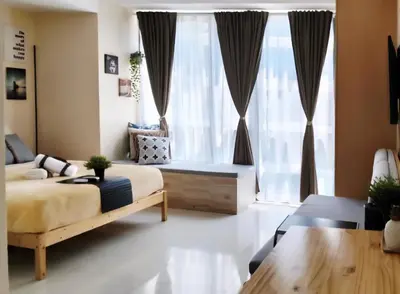 a bedroom with a bed and a large window at xxxCozy Family Retreat 8 mins walk from Venice Grand Canal Mall BGC fits 5 pax in Manila