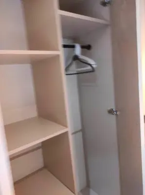a closet with a white door and shelves at Newly Interiored 1 Bedroom with Balcony, City, Manila Bay and Sunset View with Netflix, Free Access to Infinity Pool, Gym, Sauna in Manila