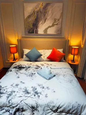 a bedroom with a bed with two lamps on it at Newly Interiored 1 Bedroom with Balcony, City, Manila Bay and Sunset View with Netflix, Free Access to Infinity Pool, Gym, Sauna in Manila