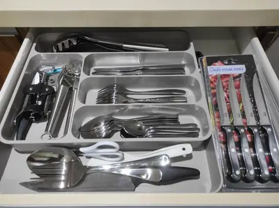 a drawer filled with silver utensils in a drawer at Newly Interiored 1 Bedroom with Balcony, City, Manila Bay and Sunset View with Netflix, Free Access to Infinity Pool, Gym, Sauna in Manila