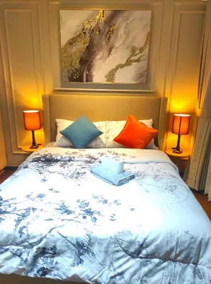 a bedroom with a large bed with colorful pillows at Newly Interiored 1 Bedroom with Balcony, City, Manila Bay and Sunset View with Netflix, Free Access to Infinity Pool, Gym, Sauna in Manila