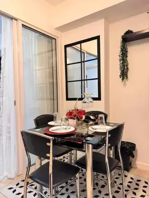 a dining room with a table with chairs and a window at A2Z Staycation at Azure Urban Residences in Manila