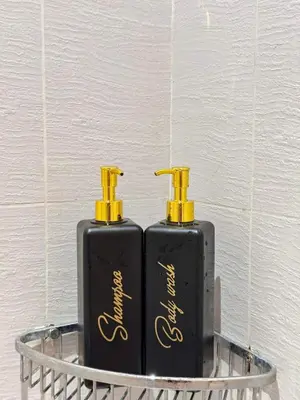two black and yellow bottles sitting on a shelf at A2Z Staycation at Azure Urban Residences in Manila