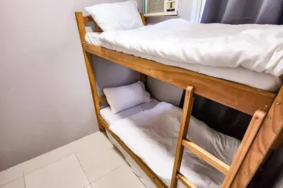 a couple of bunk beds in a room at Homey 2br Apt 5 in Makati City in Manila