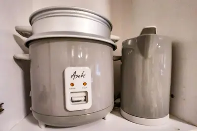 a slow cooker and a pot on top of a counter at Homey 2br Apt 5 in Makati City in Manila