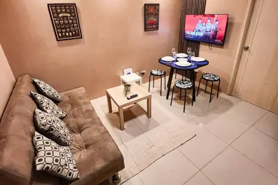 a living room with a couch and a table at Homey 2br Apt 4 in Makati City in Manila