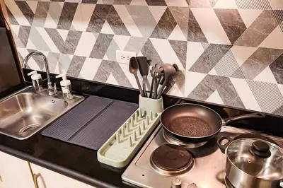 a kitchen stove with a pot and a pan on it at Homey 2br Apt 4 in Makati City in Manila