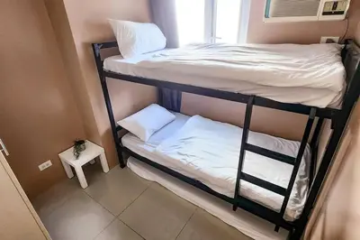 a couple of bunk beds in a small room at Homey 2br Apt 4 in Makati City in Manila