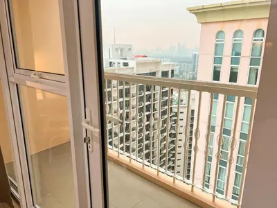 a balcony with a view of a city at Modern BGC Stay at Venice Residences #vlrtc29h in Manila