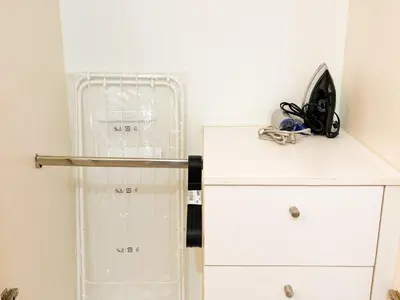 a room with a white cabinet and a counter top at Modern BGC Stay at Venice Residences #vlrtc29h in Manila