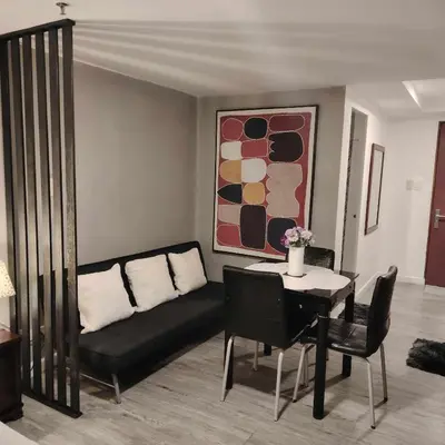 a living room with a couch and a table at ADB Avenue Tower Staycation in Manila