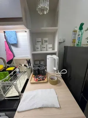 a kitchen counter with a coffee maker on it at Modern & Cozy Space near NAIA Terminal 1 in Manila