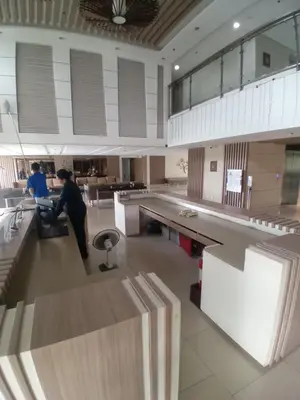 a person sitting in a chair in a large room at Modern & Cozy Space near NAIA Terminal 1 in Manila