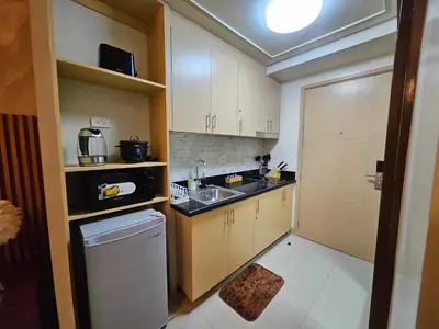 a small kitchen with a sink and a dishwasher at Lourdes' Place, Shore 2-Tower 1, 2 Beds, Pasay near Mall of Asia in Manila