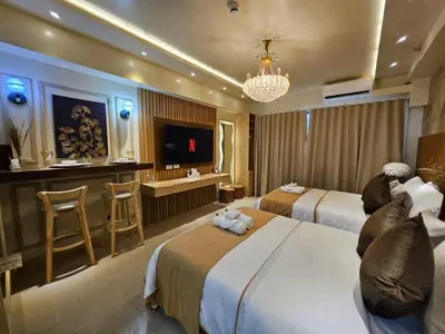 a hotel room with two beds and a bar at Lourdes' Place, Shore 2-Tower 1, 2 Beds, Pasay near Mall of Asia in Manila