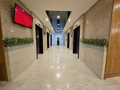 a hallway in a building with a red sign on the wall at Lourdes' Place, Shore 2-Tower 1, 2 Beds, Pasay near Mall of Asia in Manila