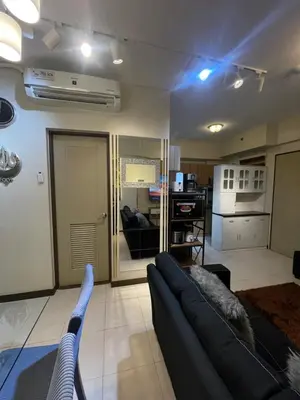 a living room with a couch and a kitchen at Mirea Residences Pasig- Two Bedroom Condo Unit with Balcony 70sqm in Manila