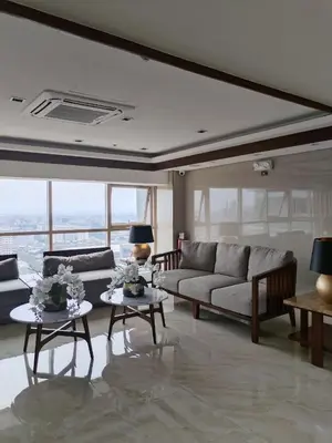 a living room with a couch and tables and windows at Coast Residence Sea View Balcony Netflix WiFi Near MOA 3146 in Manila