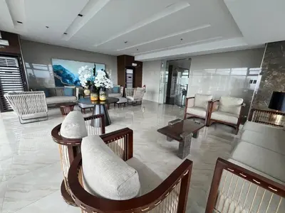 a living room with chairs and a couch and tables at Coast Residence Sea View Balcony Netflix WiFi Near MOA 3146 in Manila