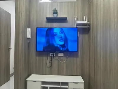 a flat screen tv hanging on a wall at 2BR Coast Residences in Manila