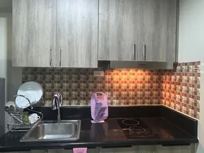 a kitchen with a sink and a counter top at 2BR Coast Residences in Manila