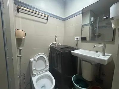 a small bathroom with a toilet and a sink at 2BR Coast Residences in Manila