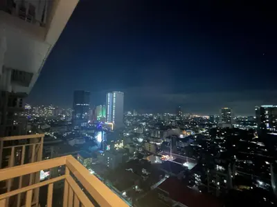 a view of a city skyline at night at 2BR Coast Residences in Manila