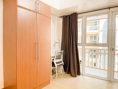 a room with a desk and a large window at Cozy Condo in Venice BGC with balcony #vlrtc28C in Manila