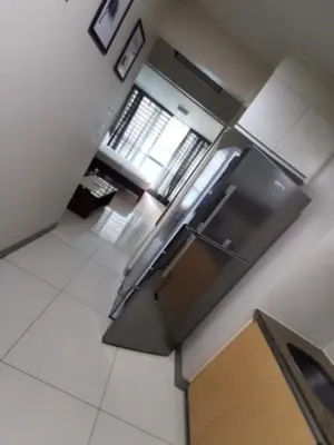 an overhead view of a kitchen with stainless steel appliances at One Uptown Residence in Manila