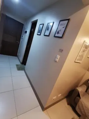 a hallway in a building with pictures on the wall at One Uptown Residence in Manila