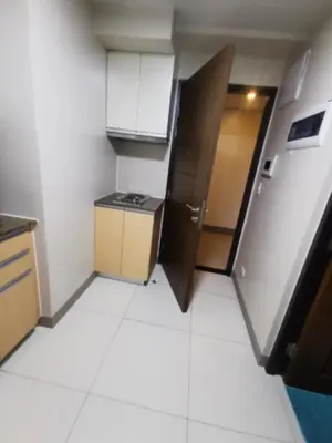 a small kitchen with a stove and a refrigerator at One Uptown Residence in Manila