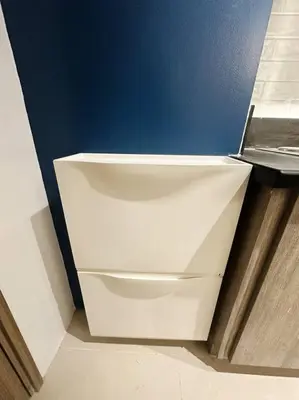 a white cabinet in the corner of a bathroom at The W Place in Manila
