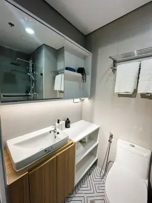a bathroom with a sink and a toilet at The W Place in Manila