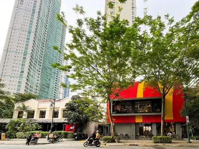 a red and yellow building in a city with tall buildings at Best Staycation in BGC Central #aatft13j in Manila