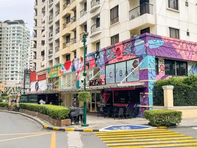 a building with a painting on the side of it at Best Staycation in BGC Central #aatft13j in Manila