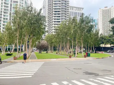 a man walking across a crosswalk in a city at Best Staycation in BGC Central #aatft13j in Manila