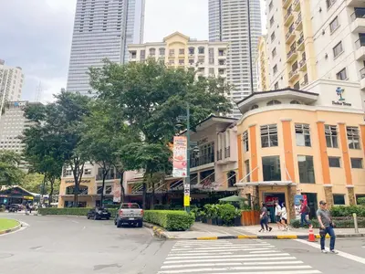 a city street with a crosswalk in front of buildings at Best Staycation in BGC Central #aatft13j in Manila