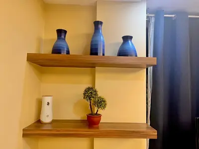 a shelf with blue vases and a plant on it at 7H Kiel Hotel NAIA Terminal 3 in Manila