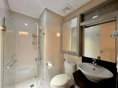 a bathroom with a toilet and a sink and a shower at 7H Kiel Hotel NAIA Terminal 3 in Manila
