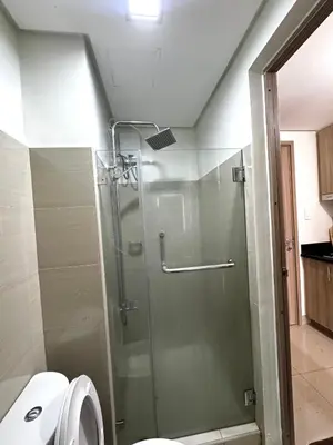a bathroom with a glass shower with a toilet at European Inspired Shore 2 Residences in Manila