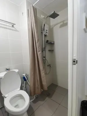 a bathroom with a toilet and a shower at Jazz Apartment Unit in Manila
